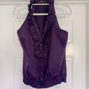 Blouse with front detailing and a high neck.